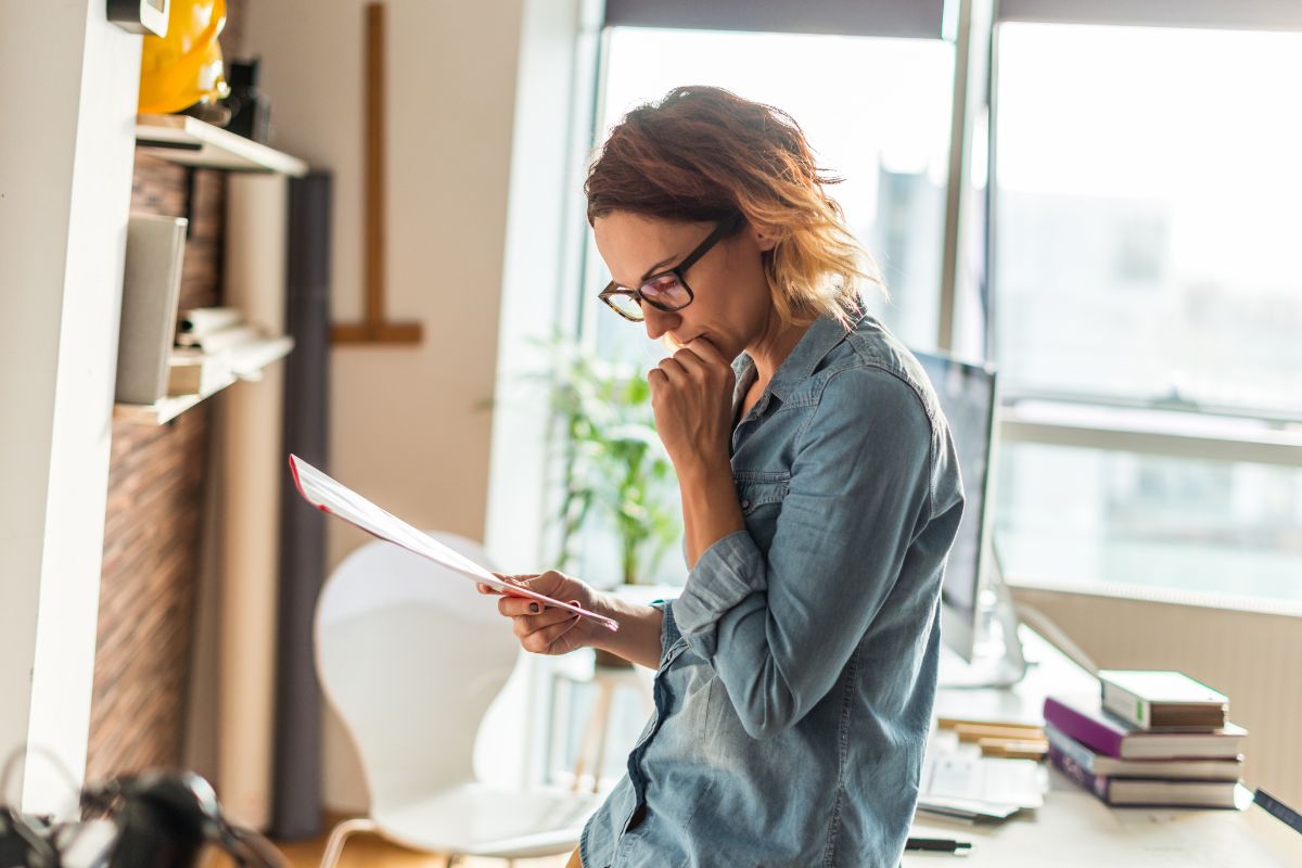The photo is about a woman reviewing progress.