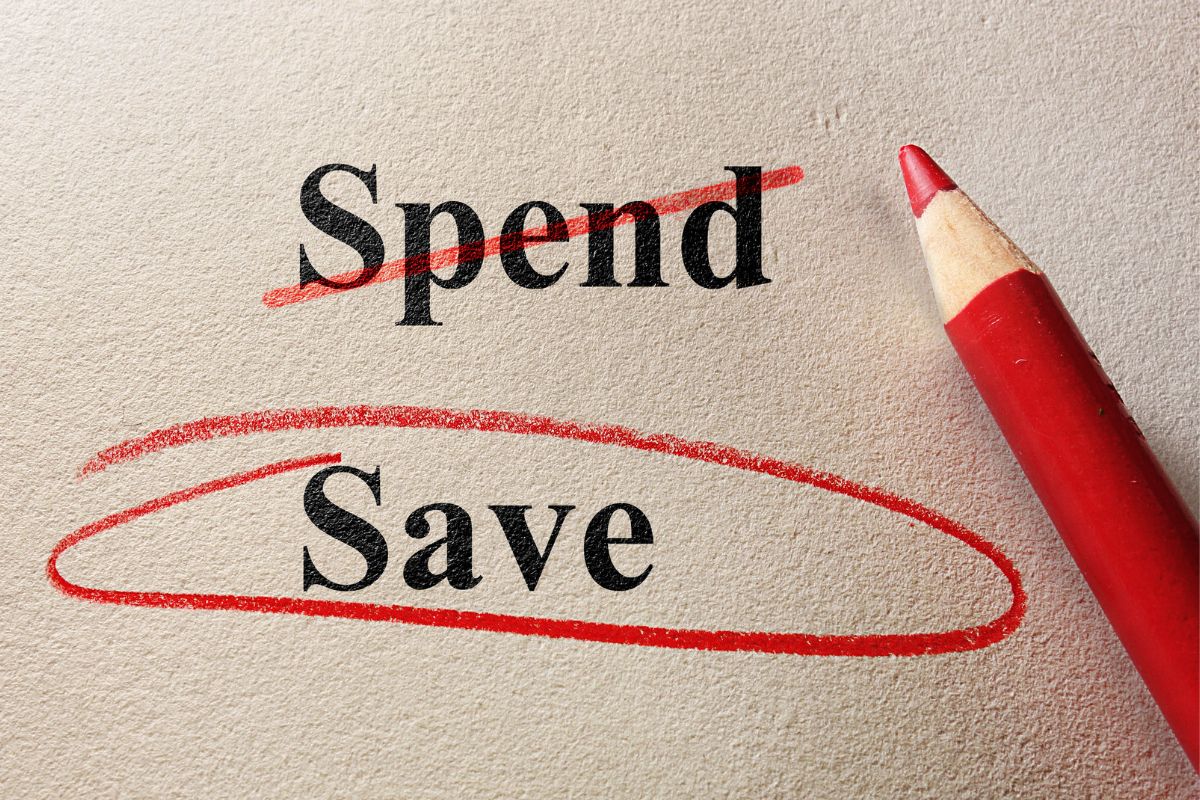 The picture tells about a red pen and a piece of paper with notes and marks which refers to living below you means creating a strong foundation for generational wealth.
