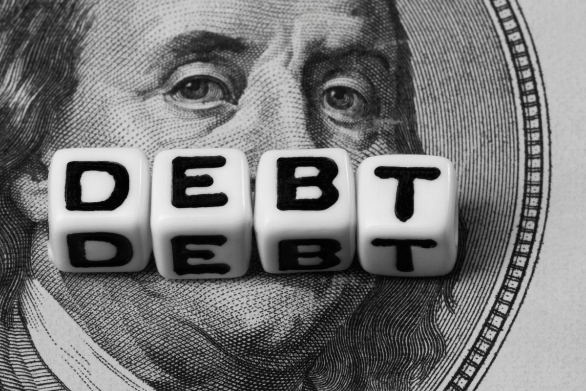 The image tells about a dollar icon and cubes with letters which means avoiding unnecessary debt ensures future generations don't fall into financial traps. 
