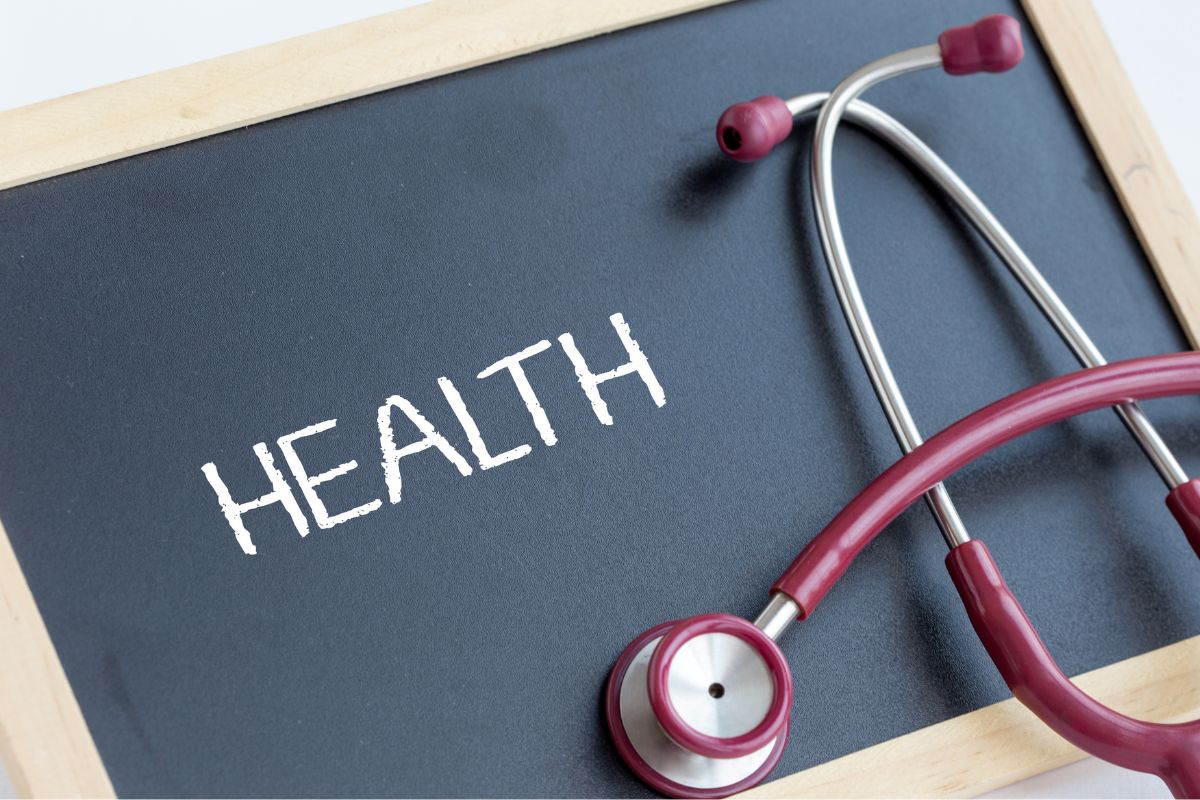 The picture shows a stethoscope and a board with health wording.