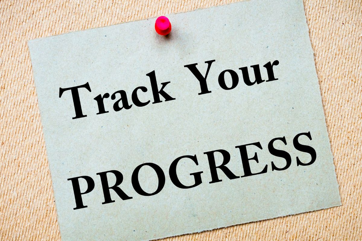 The picture shows a paper with Track Your Progress written.