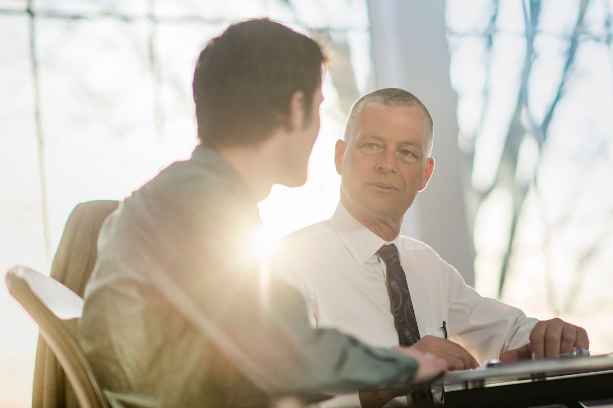 The picture shows a man with his mentor.