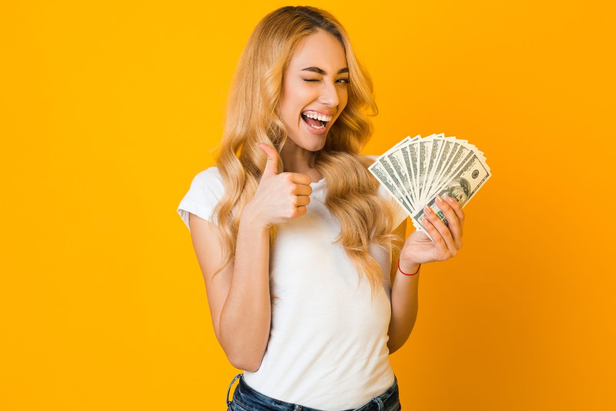 The picture shows a woman holding money.