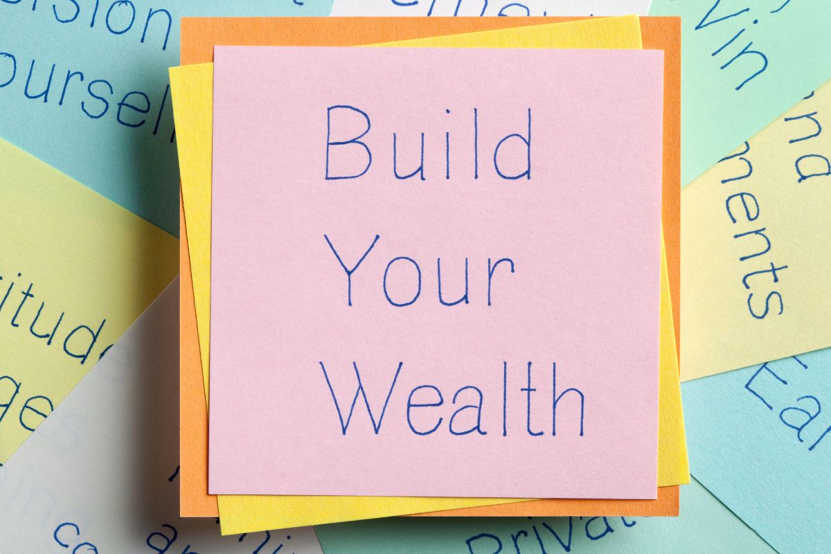 The image shows a paper with Build Your Wealth written.