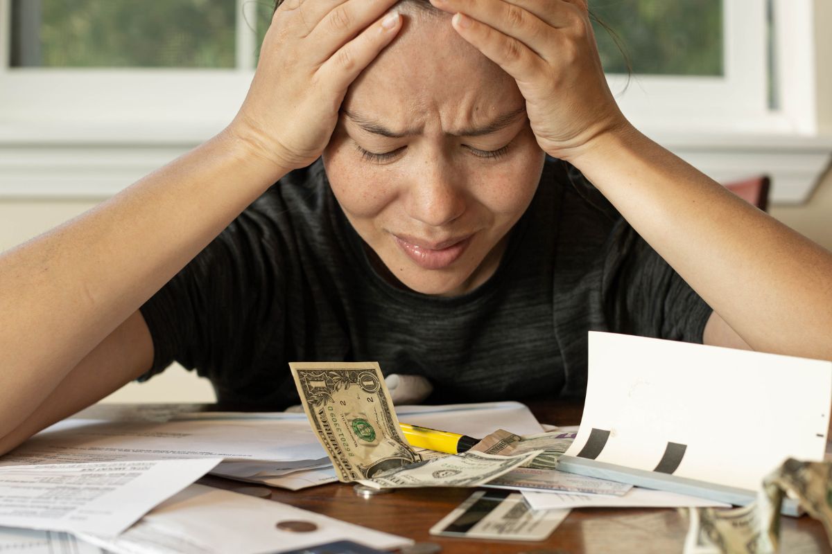 The photo shows a woman with financial struggle.