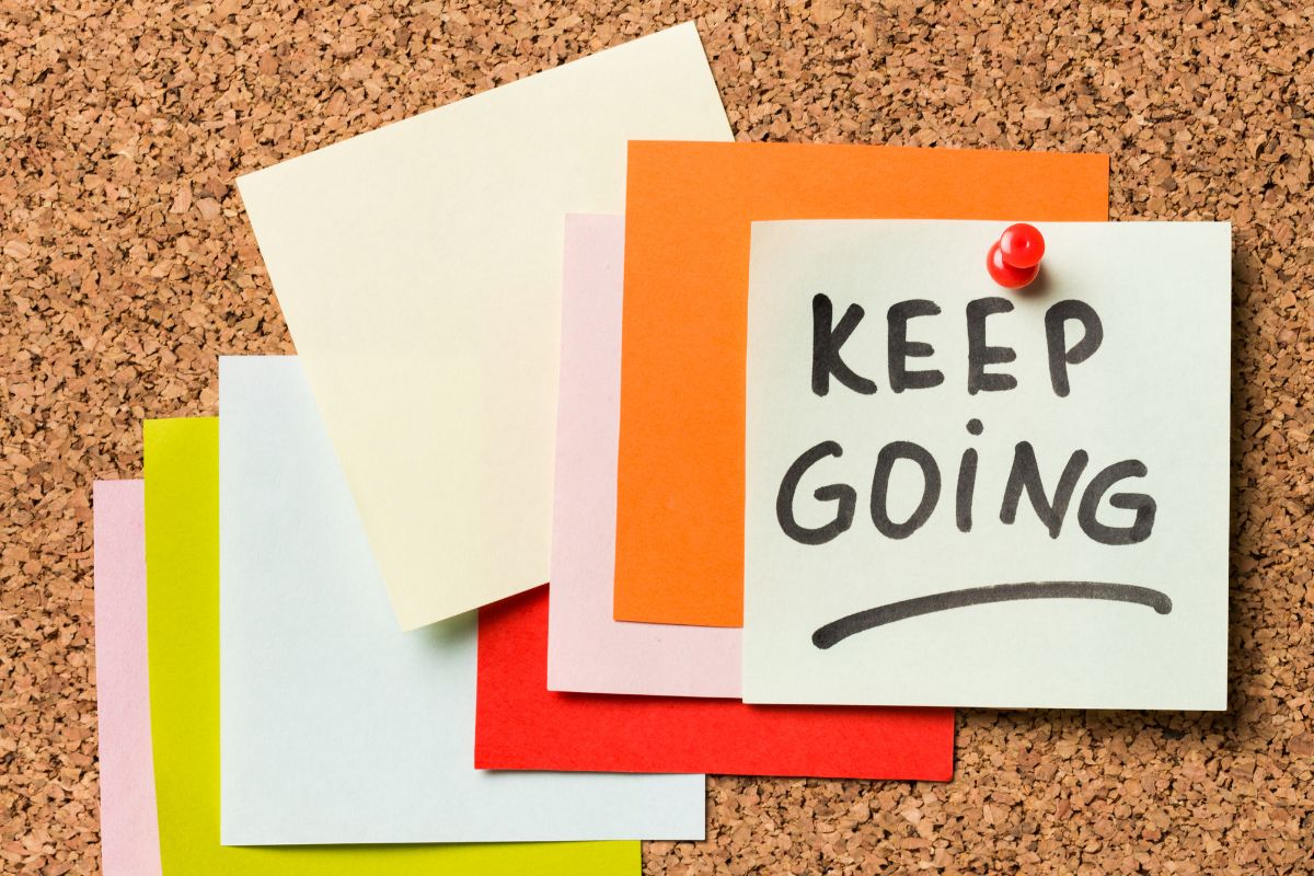 The image shows paper with the wording keep going.