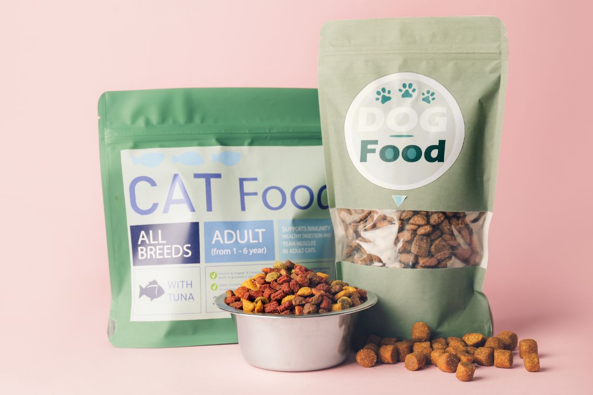 The image shows two packs of cat food and a bowl of cat food which means by bulk pet food is an easy way to take care of your pet while sticking to a budget.