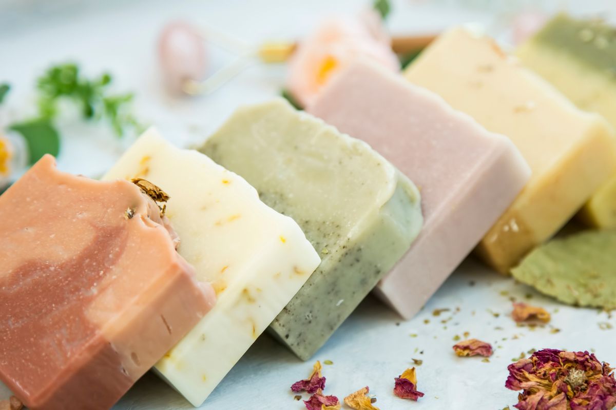 The picture tells about soap bars with leaves which refers to buying personal care items in large value packs as a simple way to save on everyday necessities.