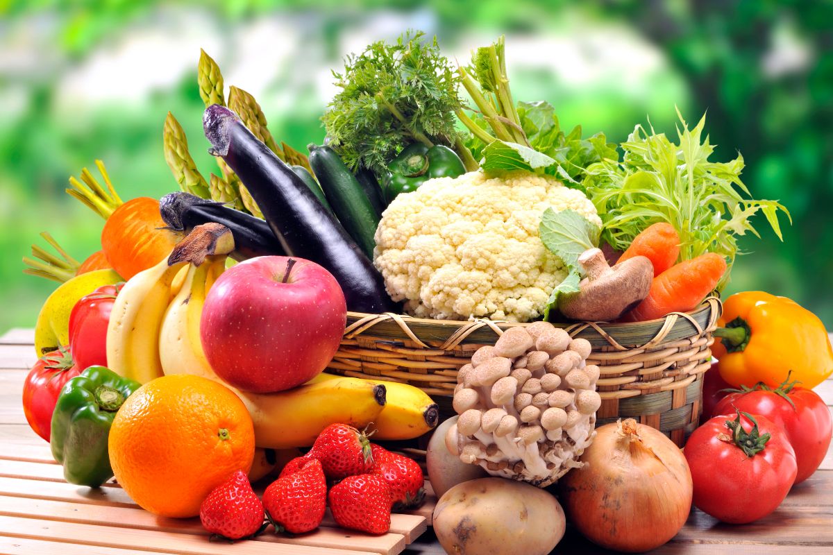 The picture tells about a basket of fruits and vegetables on the table referring to looking for ugly produce subscription boxes is a great way to save money while eating healthy.
