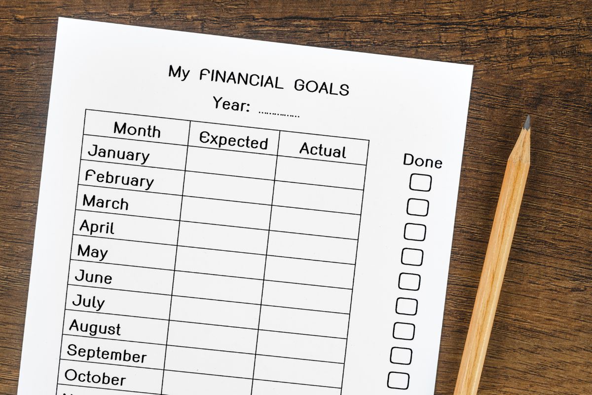 The picture tells about a pen and a piece of paper with notes which refers to setting clear financial goals make smarter choices that bring you closer to financial independence.