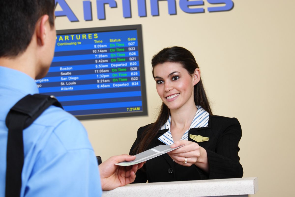 The image shows a counter giving a ticket to the customer referring to purchases of discounted bulk airline miles is a smart way to make travel more affordable.