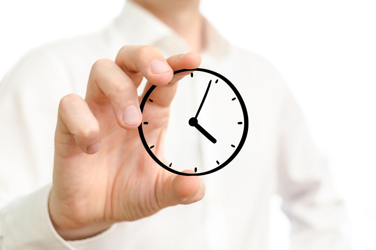 The picture of a man's hand holding a clock which refers to the use of a time auction system ensures the time is spent where it makes the most money.
