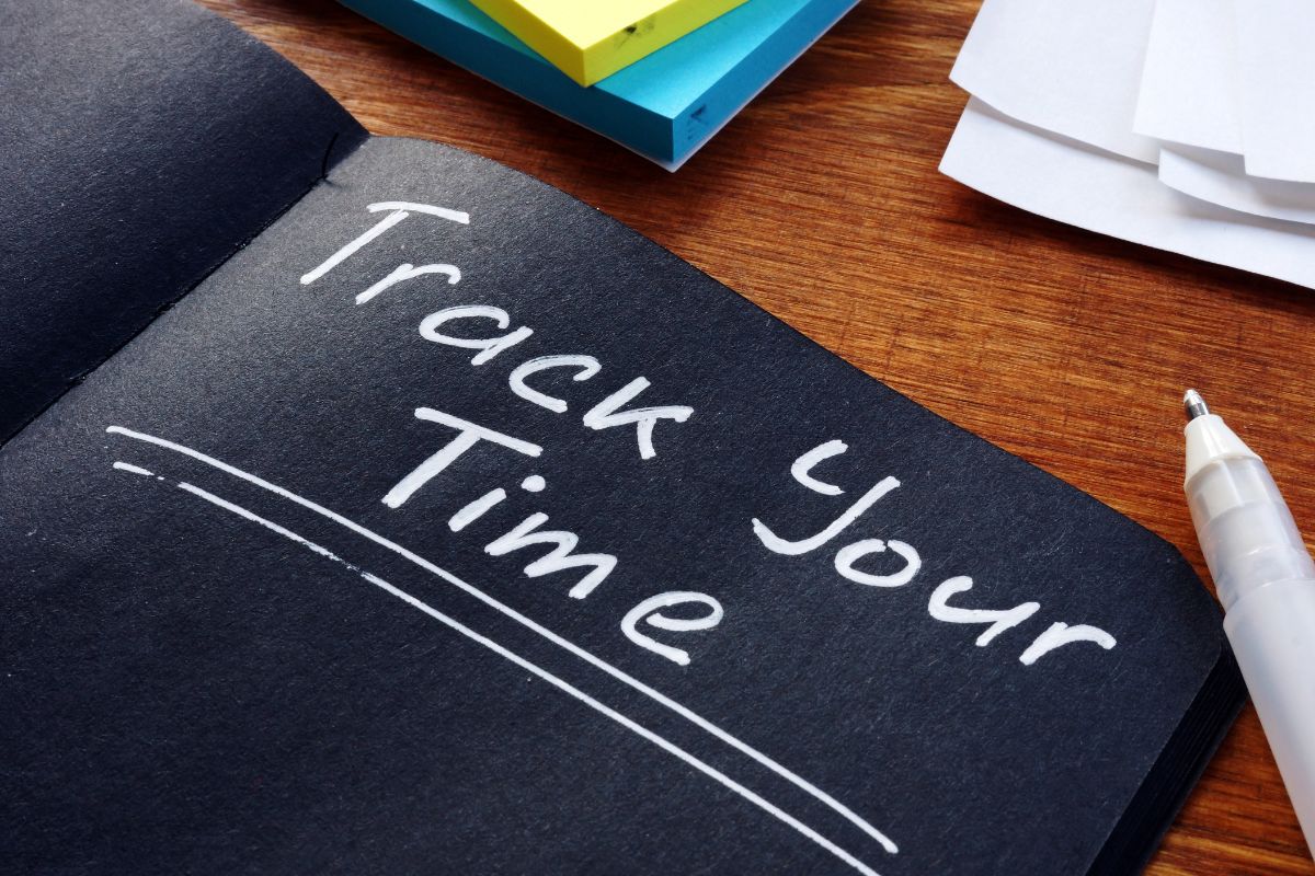 The image shows a black notebook with the Track Your Time wording.