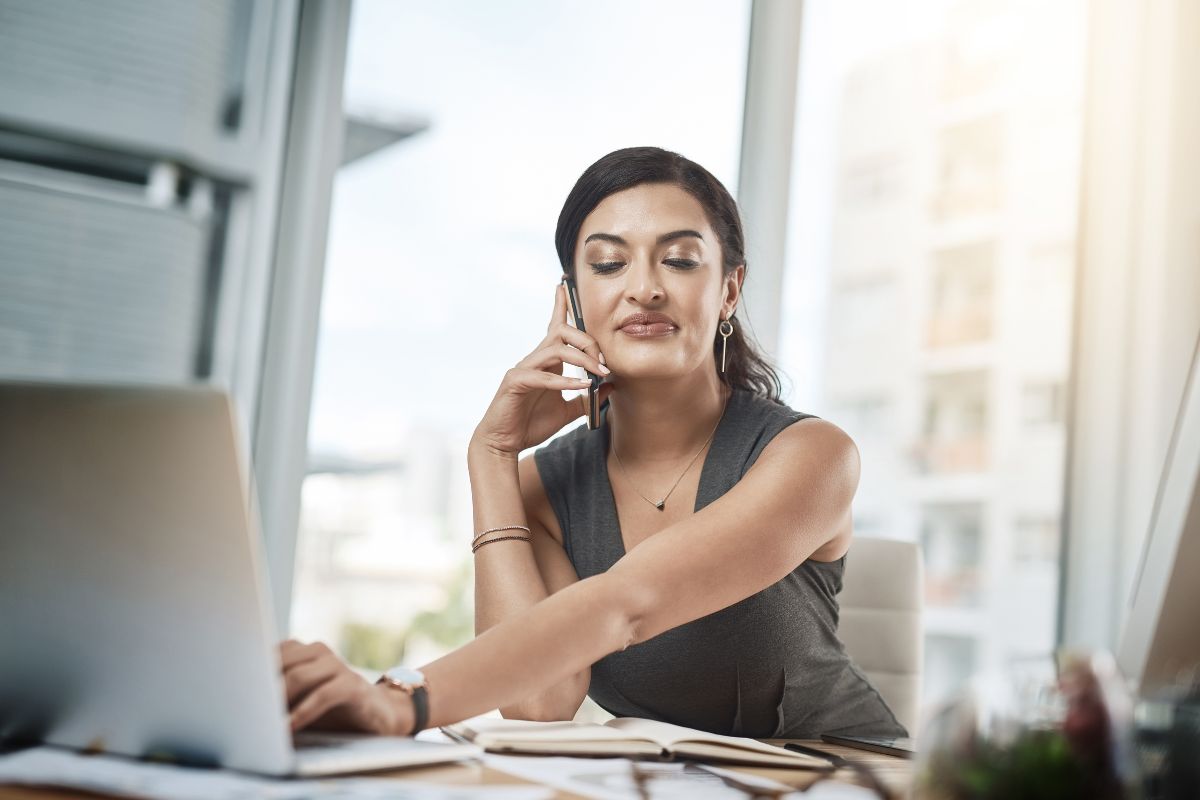 The photo tells about a girl using a laptop while having a call on the phone referring to  adopting a one-touch rule that prevents small tasks from piling up and taking over the day. 