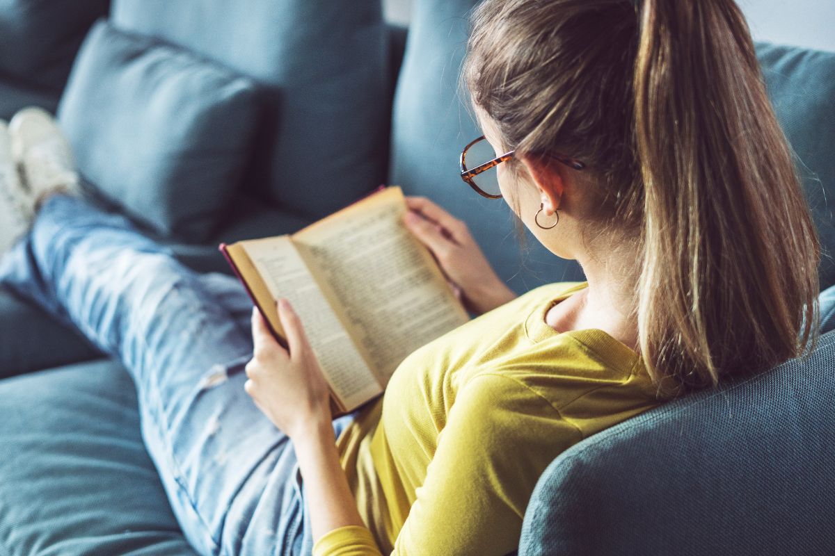 The image shows a lady reading a book.