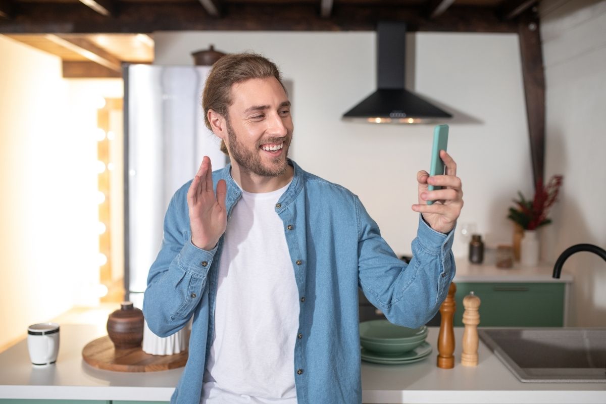 The picture of a man doing a video message.