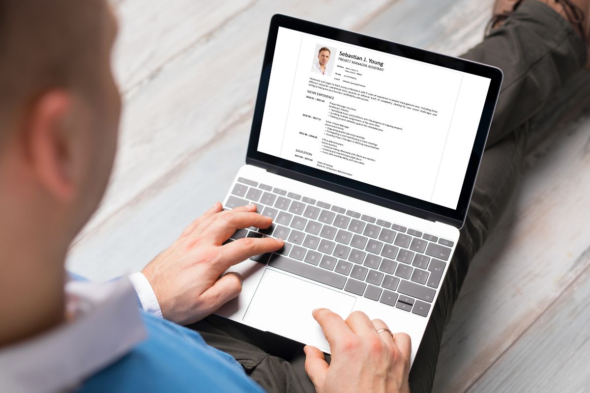 The photo shows a man making a personalized resume.