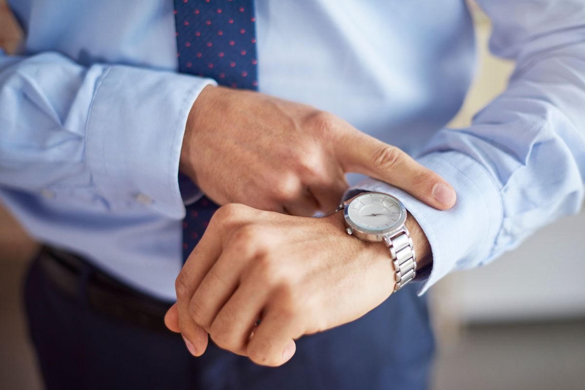The picture of a man's hand checking his watch refers to learning why time freedom is so important by having the power to choose how each day is spent.