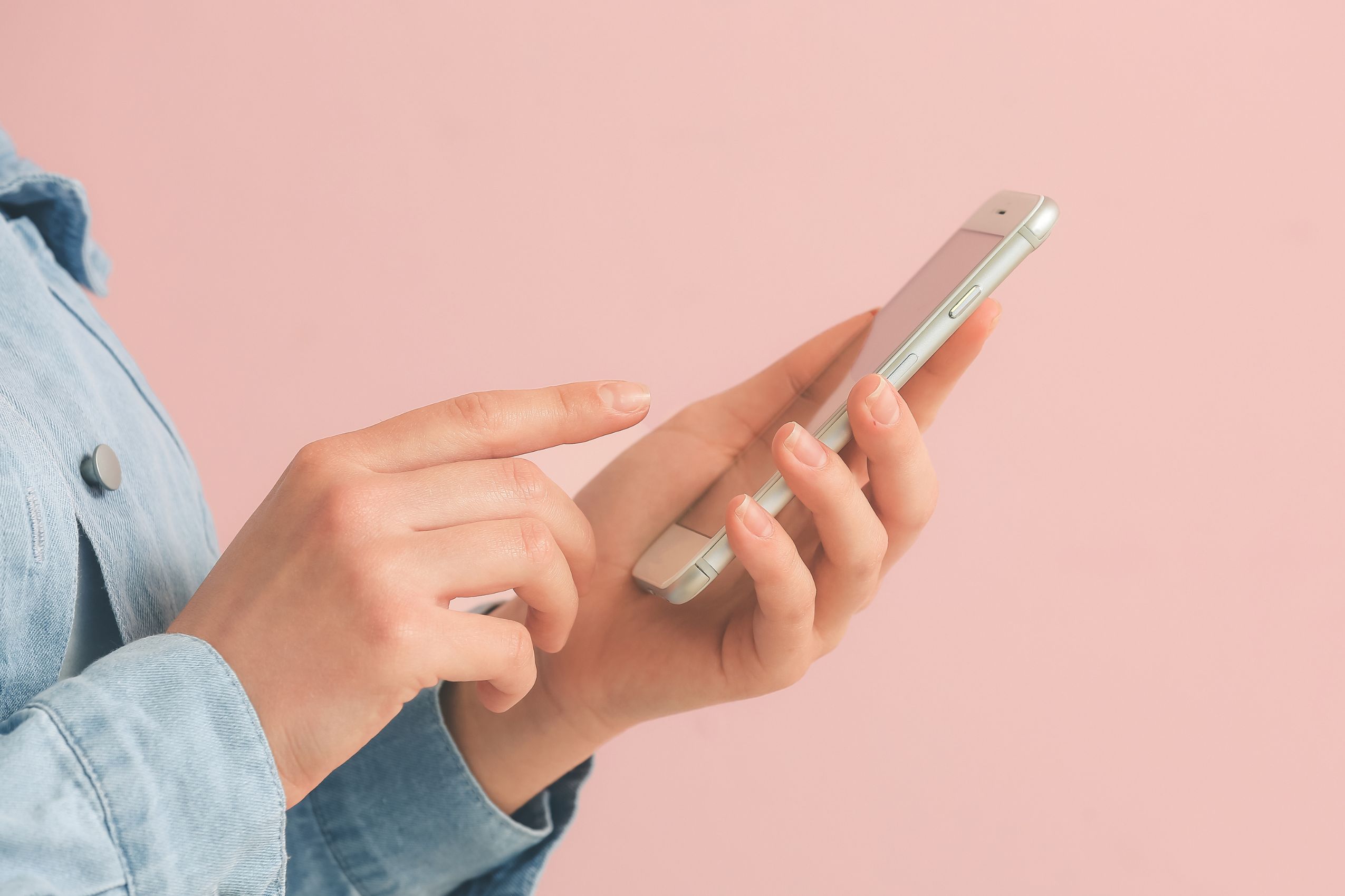 The image shows a girl's hand using a phone referring to subscription services that add up fast and can quietly drain your budget, checking and cutting it can free up extra cash.