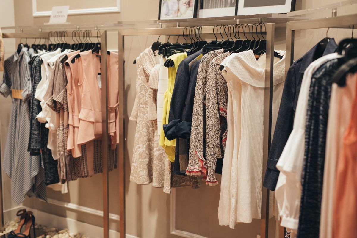 The picture tells about hung clothes in the rack indicating that designer clothing costs a premium,  wearing what you already own helps avoid overspending.