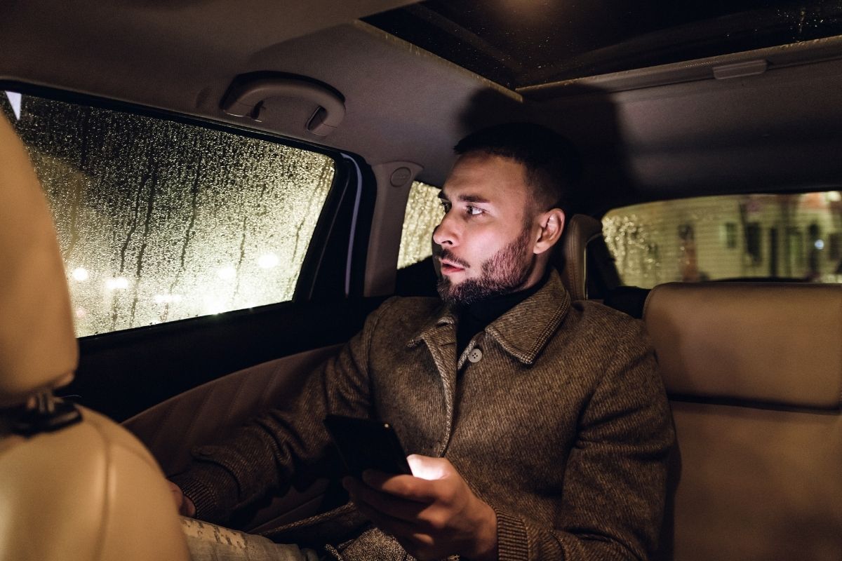 The picture shows a man riding an Uber.