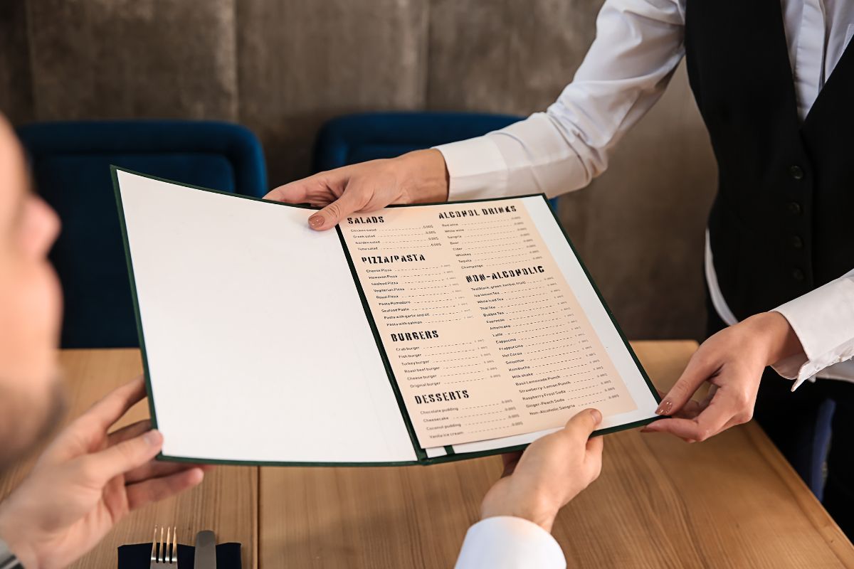 The photo shows a man ordering at a restaurant.