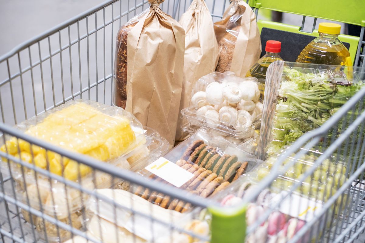 The picture shows a cart full of grocery items inside which means impulse purchases at checkout lines can add up over time, waiting a few minutes before buying can help decide if it's really needed.