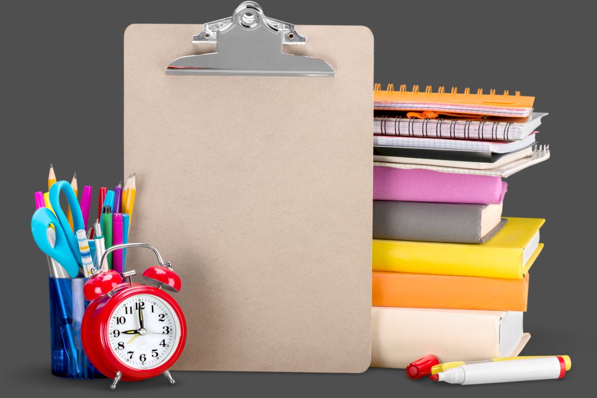 The picture shows a notebook, pens, a clock, a clipboard, and a marker which refers to unused or excessive office supplies that can lead to wasting money and clutter keeping office purchases simple helps control spending.