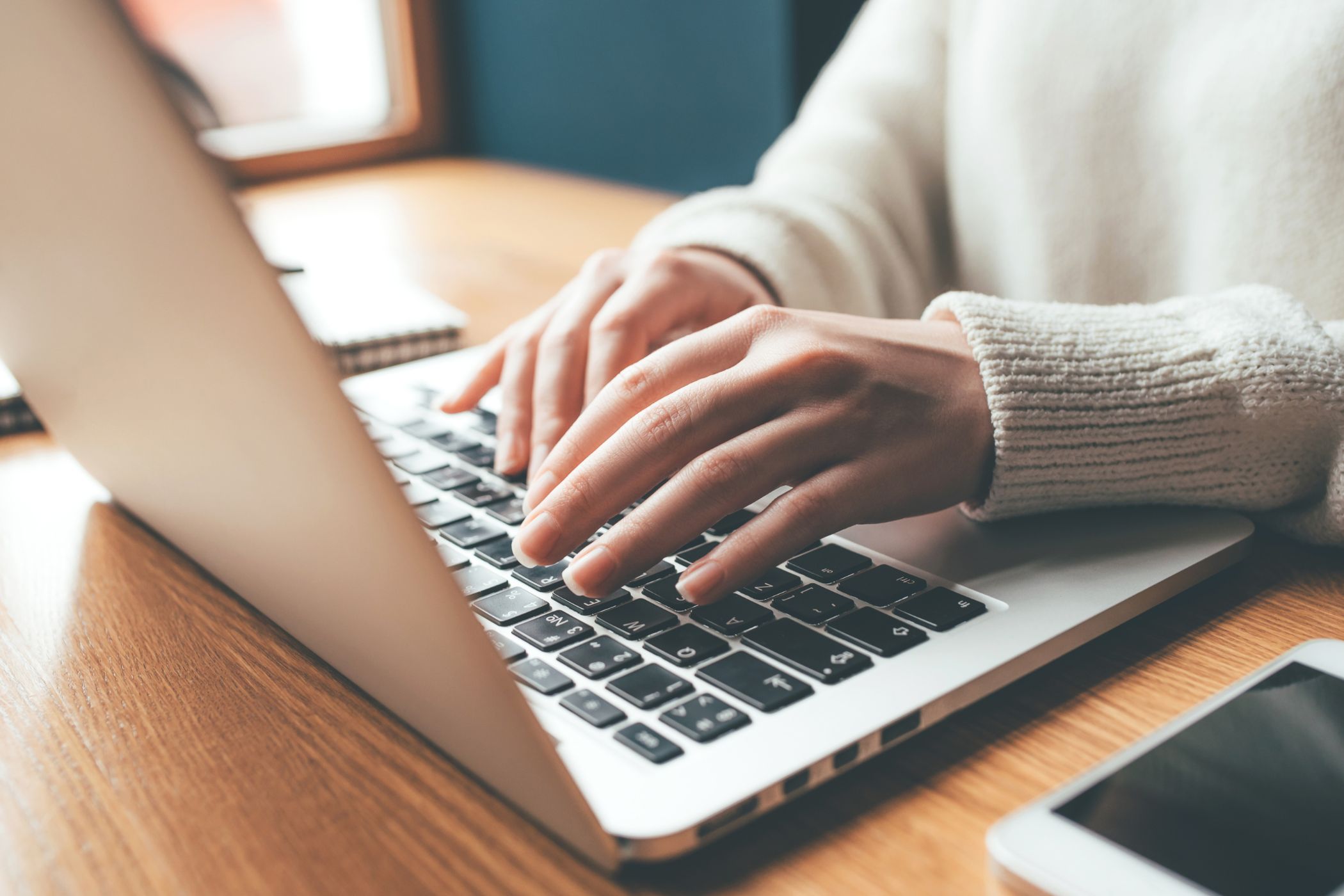 A woman's hand working on a private membership group.