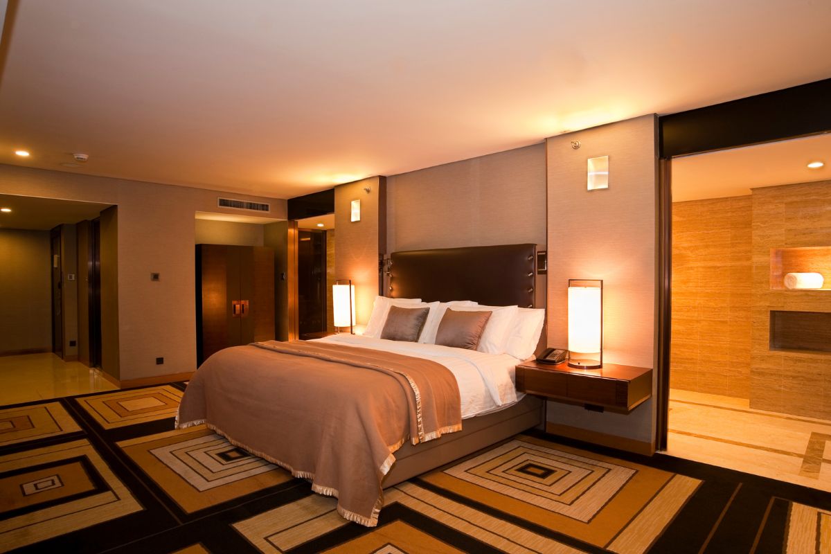 The photo of a cozy bed indicates that high-end hotel rooms can add extra payment, and cheaper options can be a good offer as much as comfort without the steep price tag.