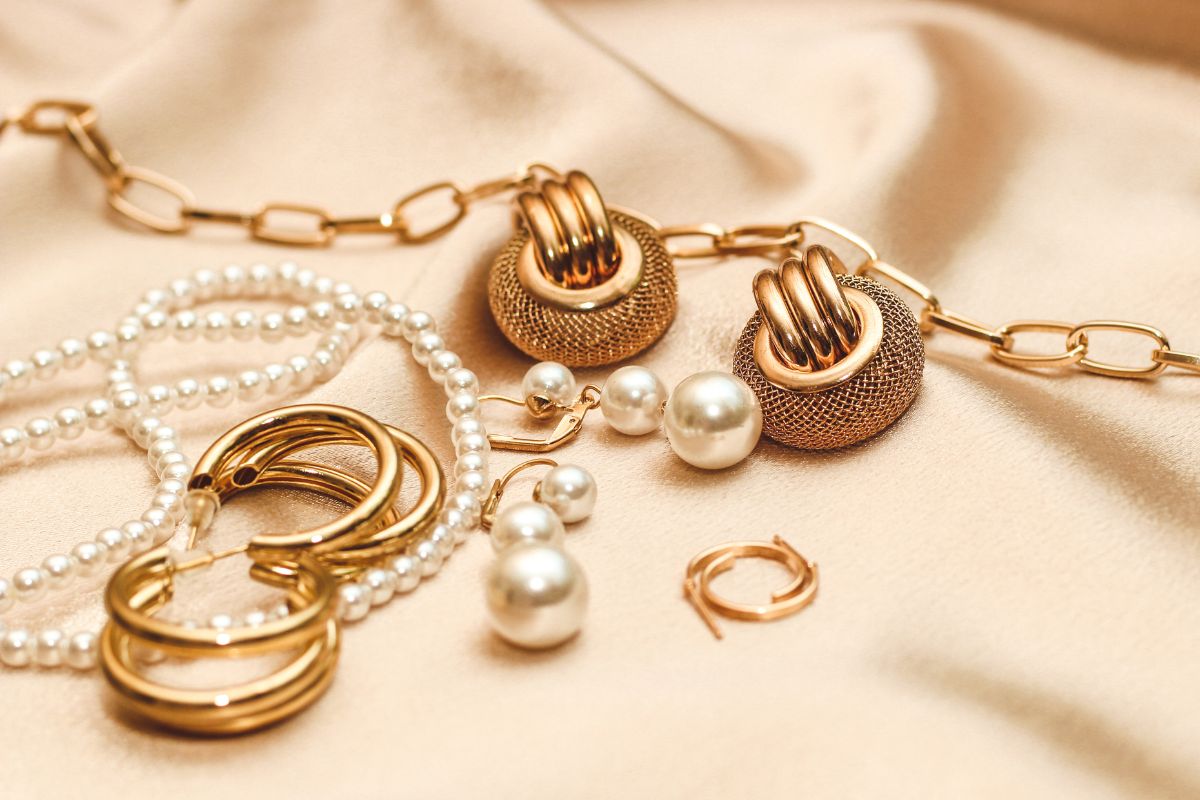 The picture tells about earrings and necklaces on the fabric which refers to overpriced fast fashion jewelry often a waste of money, buying a well-made piece that won't break the bank.