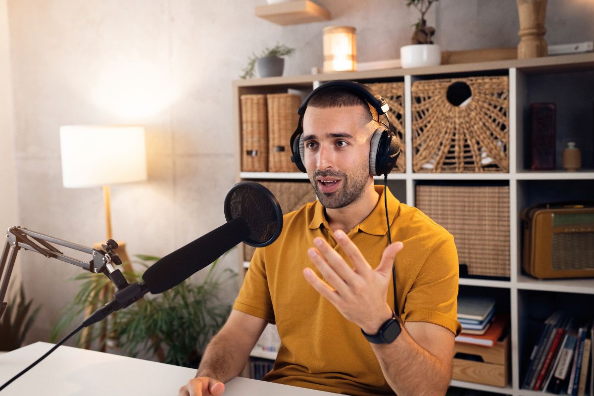 The image shows a man working on a podcast.