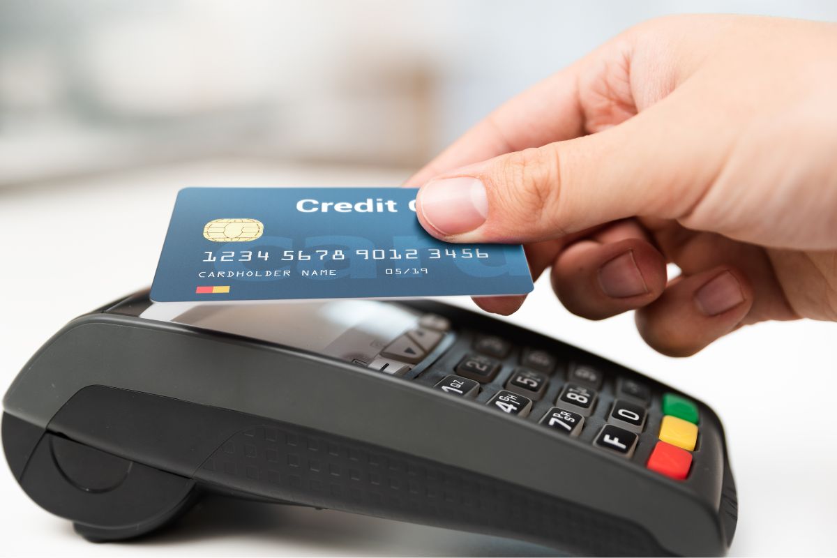 The picture tells about a machine and a girl's hand tapping the credit card to it indicating stuff you have to charge because you can't afford it is an easy way to overspend, paying in cash will reduce the stress of unpaid bills.