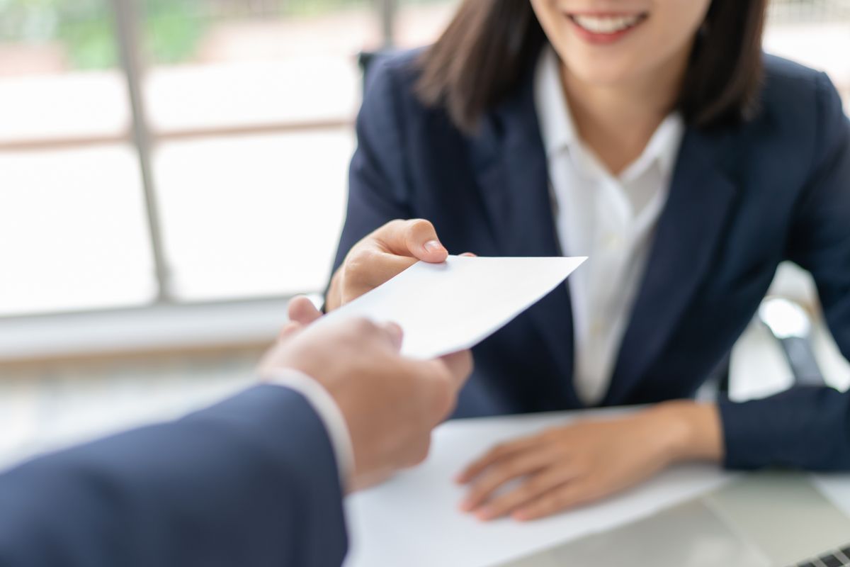 The picture shows a woman receiving a salary.