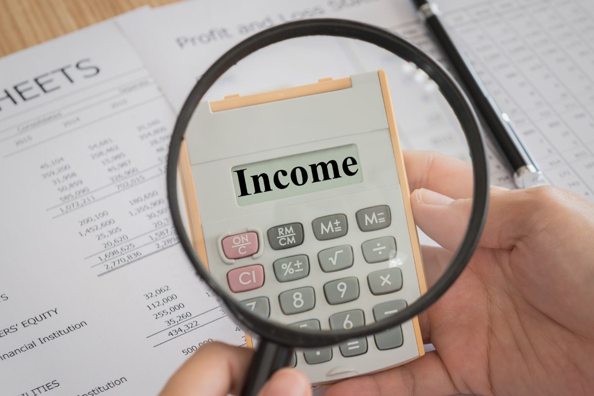 The picture shows a man holding a calculator.