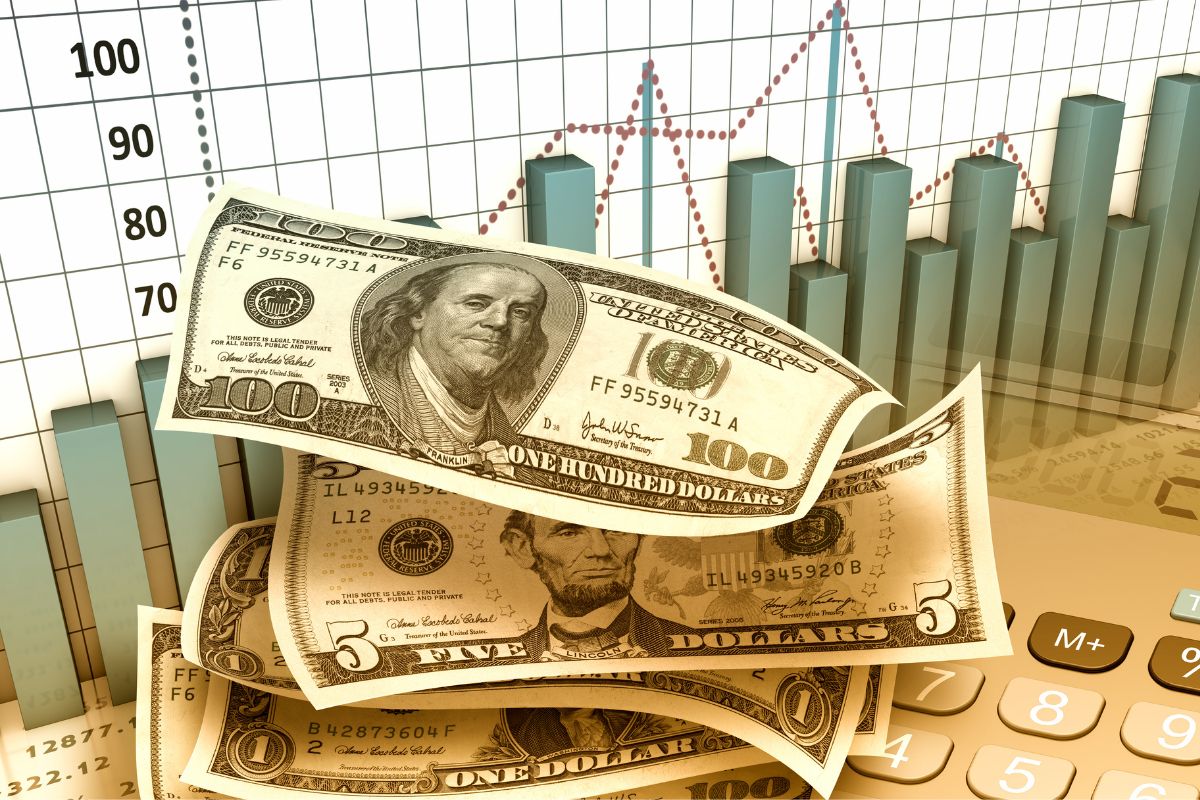 The photo tells about a graph, a calculator, and dollar bills representing avoiding investing due to market uncertainty and missing years of potential growth, staying consistent matters more than waiting for the right time.