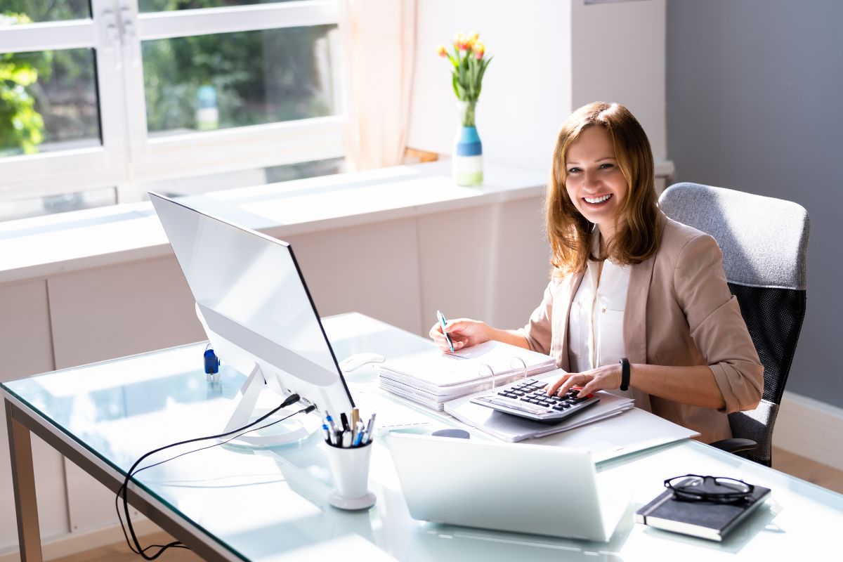 The picture shows a woman working on remote bookkeeping.