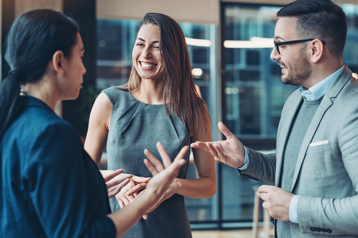 The picture shows a group of people networking.