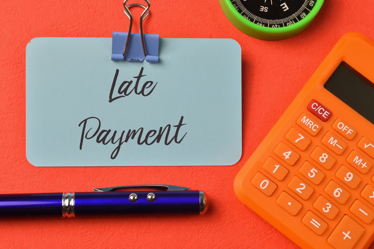 The picture tells about a calculator, a compass, a pen, and a piece of paper with notes and a pin indicating that paying unnecessary fees often charges hidden costs, reviewing statements and setting reminders can help avoid extra charges.