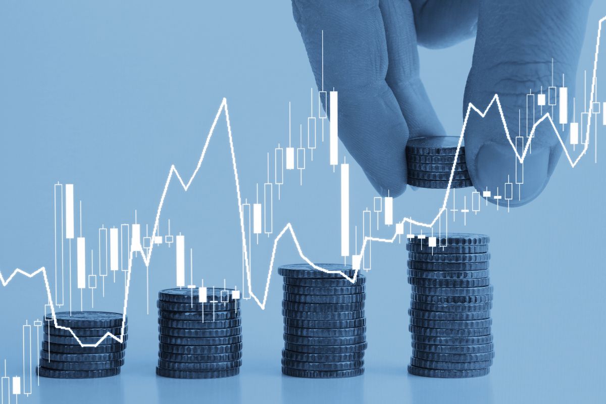 The picture of coins stocks, line graphs, and a man's hand putting coins at the last level which means investing in things you don't understand often leads to losses, taking time to learn prevents costly mistakes.
