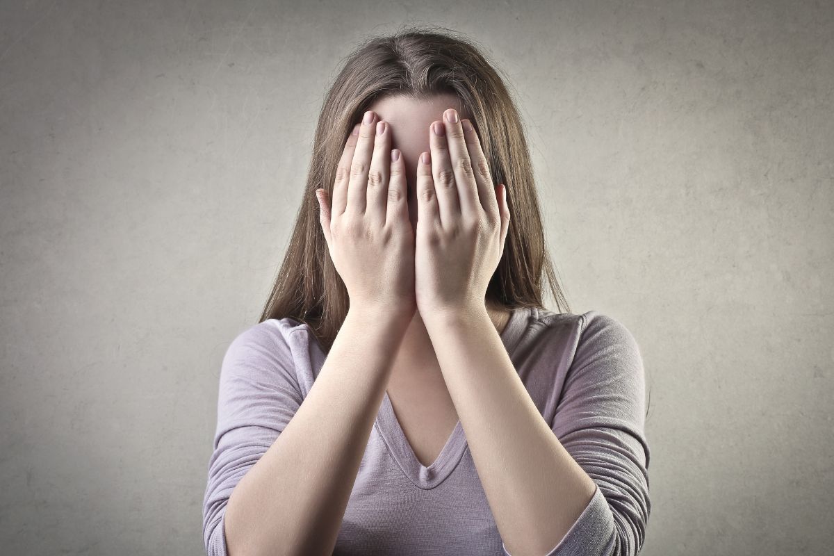 The image shows a woman with fear.