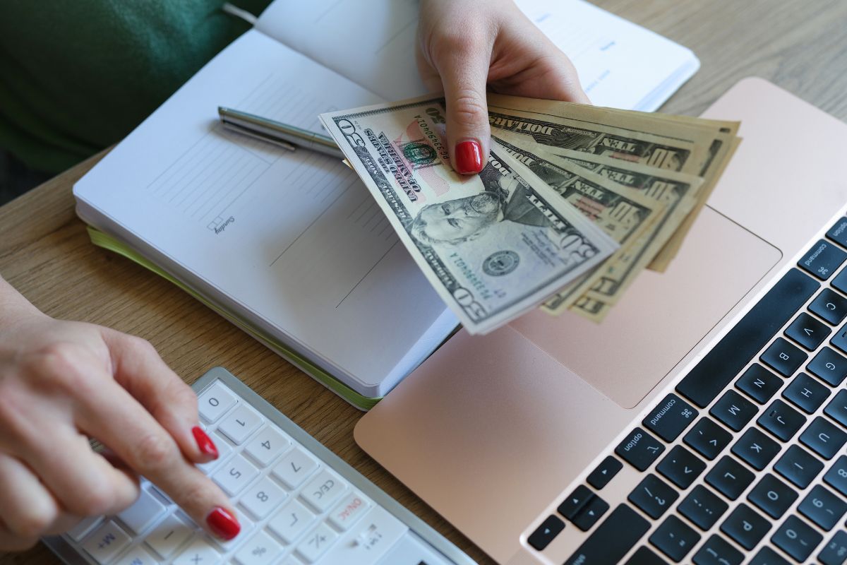 The photo shows a lady's hand budgeting.