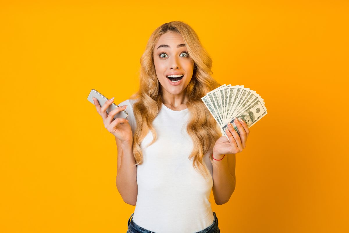The photo shows a woman holding dollar bills.