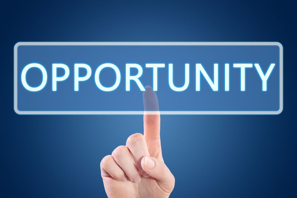 A woman's hand pointing to the opportunity wording.