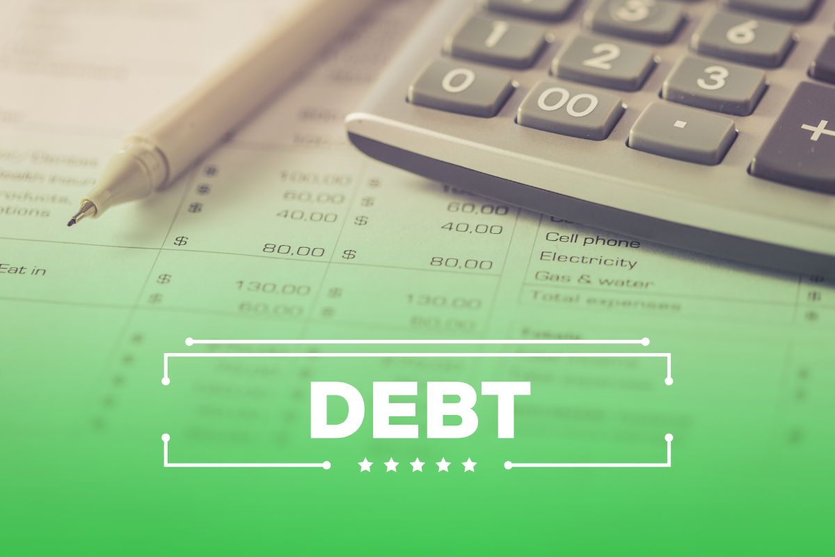 The photo shows a pen, a piece of paper with notes and numbers, and a visual screen with a note indicating how to get out of debt before you reach retirement. 