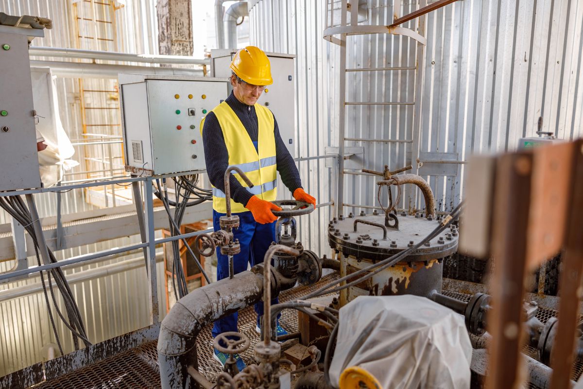 The image shows tanks and a man manipulating the machine referring to a petroleum engineer designing ways to extract oil and gas from the earth with a high-earning career.
