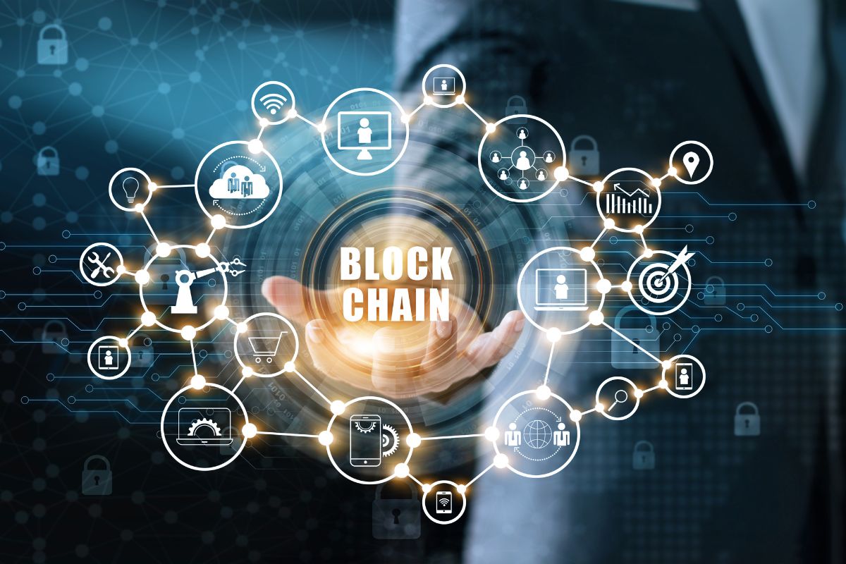 The photo tells about a man's hand showing visual icons and notes on the screen which refers to a blockchain developer creating secure digital systems and one of the high-paying careers.