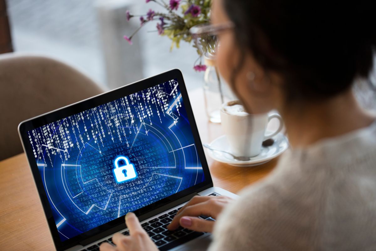 The image tells about a girl using a laptop with a screen display which means cybersecurity consultants help businesses protect their data from hackers with a high-paying career in tech. 