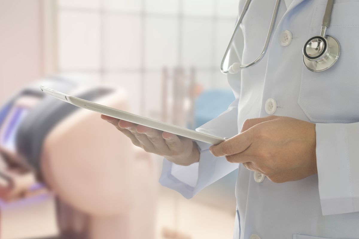 The image shows a machine and a doctor holding a tablet device and a stethoscope referring to medical illustrator helps doctors and students understand the human body, which is a high-paying career worth considering.