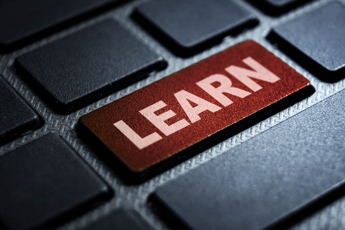 The picture shows a keyboard with a word referring to learning how to make work optional and having control over time and money.